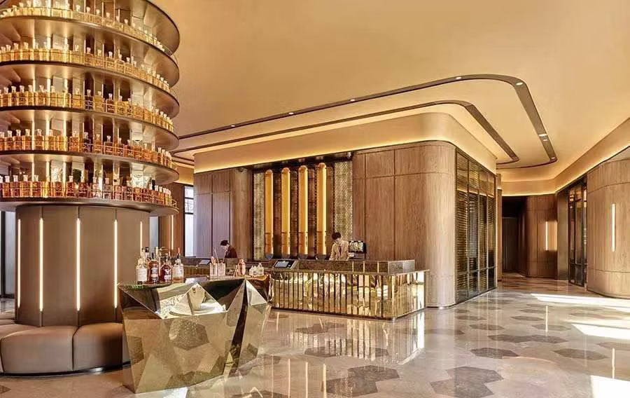 The golden whiskey bar interior of the Crystal Orange brand concept