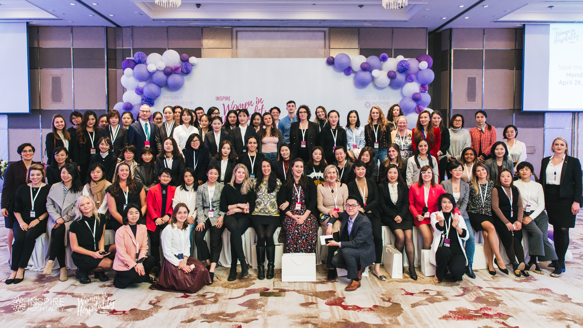 Delegates of the Inspire Women in Hospitality Forum gathered in a ballroom beneath purple lanterns